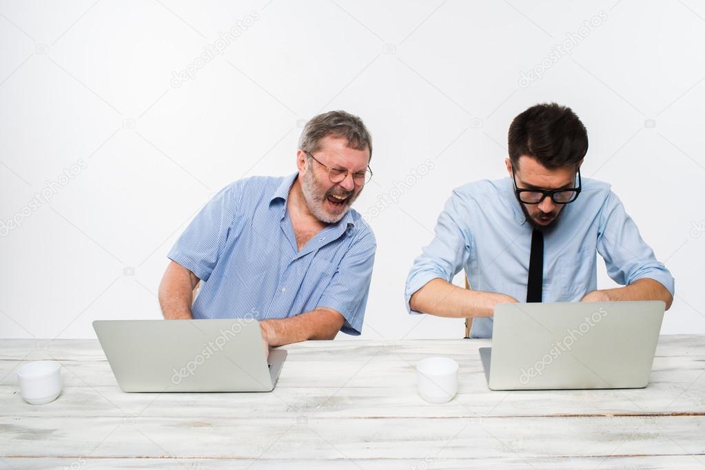 The two colleagues working together at office on white background