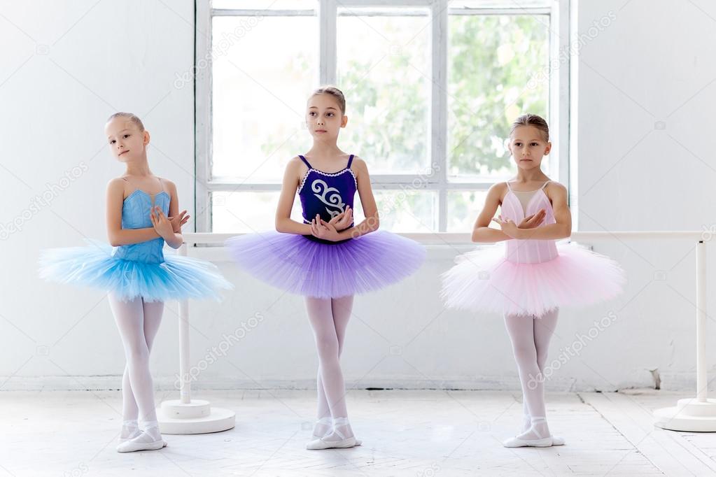 Three little ballet girls in tutu and posing together