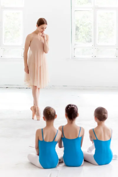 Tiga balerina kecil menari dengan guru balet pribadi di studio tari — Stok Foto
