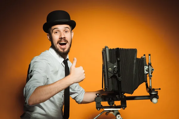 Young man with retro camera — Stock Photo, Image