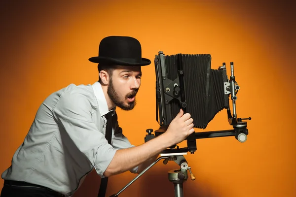 Young man with retro camera — Stock Photo, Image