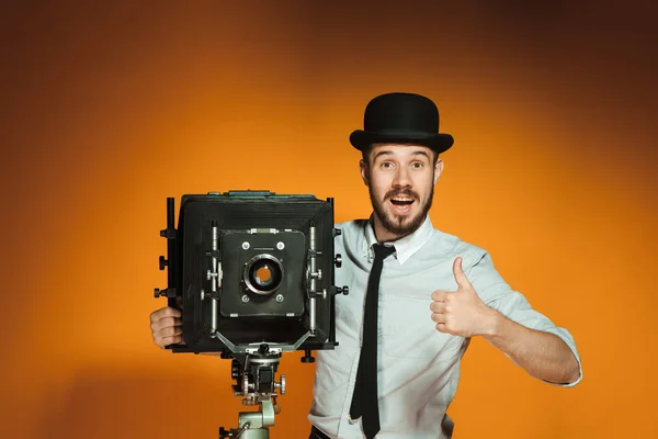 Young man with retro camera — Stock Photo, Image