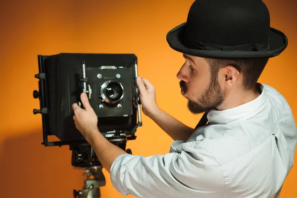 Young man with retro camera — Stock Photo, Image