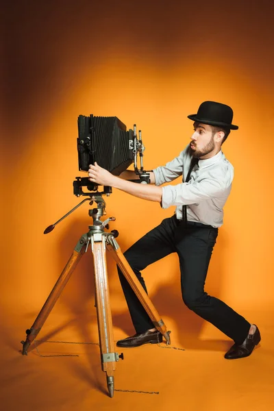 Young man with retro camera — Stock Photo, Image