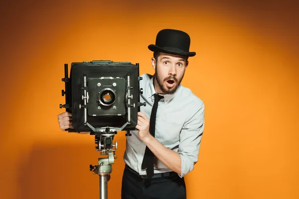 Young man with retro camera — Stock Photo, Image