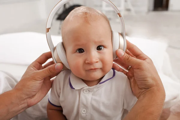 Baby with headphones listening to music — Stock Photo, Image