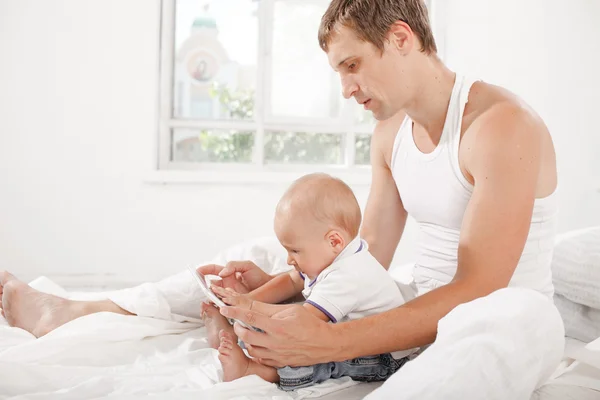 Young father and his nine months old son with digital tablet — Stock Photo, Image