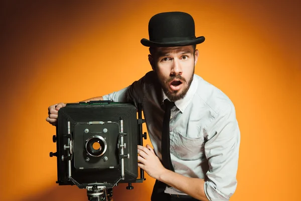 Young man with retro camera — Stock Photo, Image