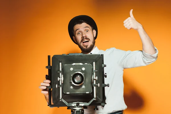 Young man with retro camera — Stock Photo, Image