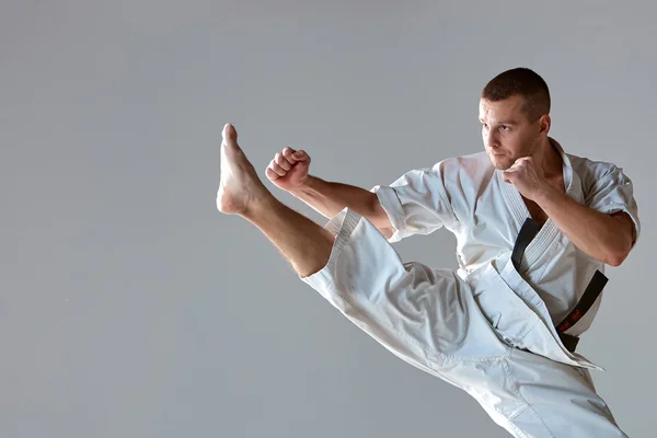 Man in white kimono training karate — Stock Photo, Image