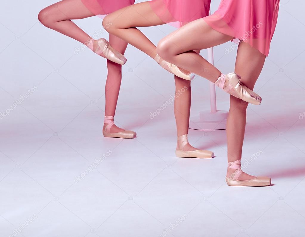 Ballerinas stretching on the bar