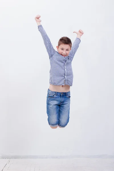 Happy young boy jumping  on white background — Stock Photo, Image