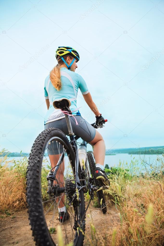 Young girl riding bicycle outside. Healthy Lifestyle.
