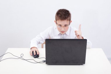 Boy using his laptop computer clipart