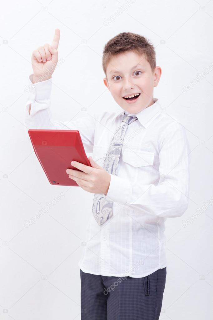 Portrait of teen boy with calculator on white background