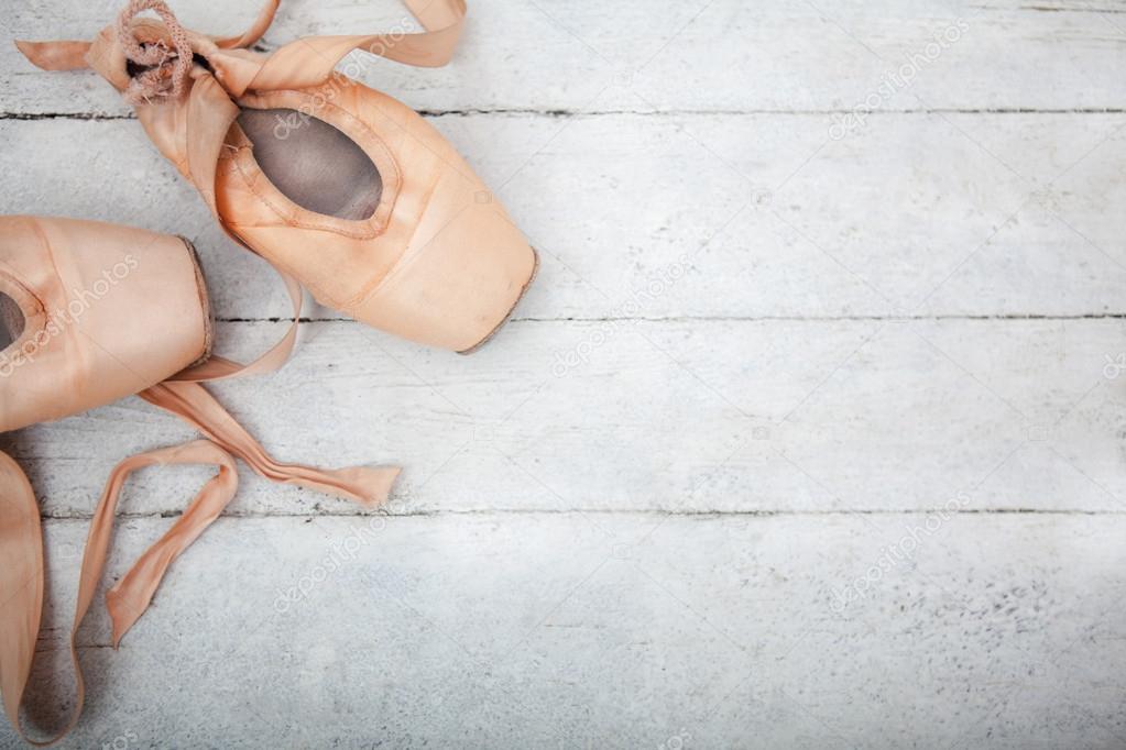 Pointe shoes on wooden background