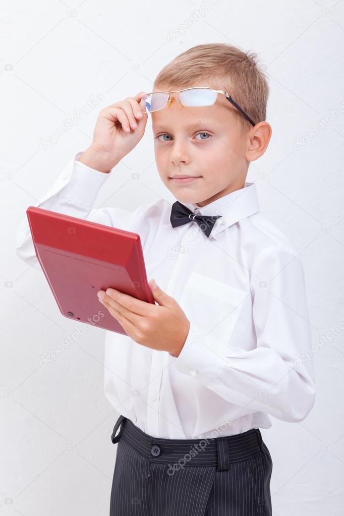 Portrait of teen boy with calculator on white background