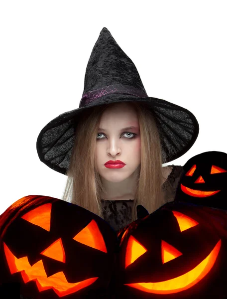 Halloween witch with a carved pumpkin — Stock Photo, Image