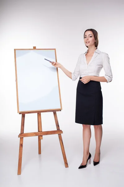 Молодая деловая женщина показывает что-то на белом фоне — стоковое фото