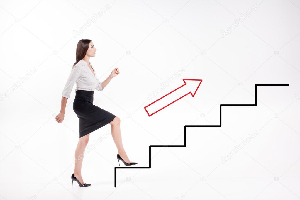 Young businesswoman walking up on stairs