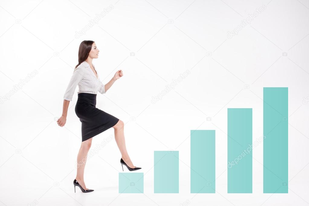 Young businesswoman walking up on stairs