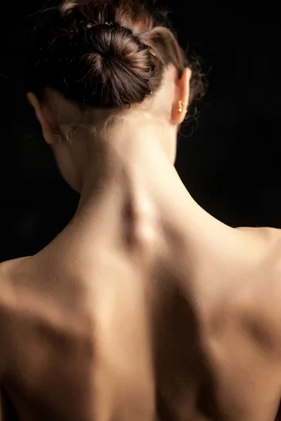 Beautiful woman, back view on dack background — Stock Photo, Image