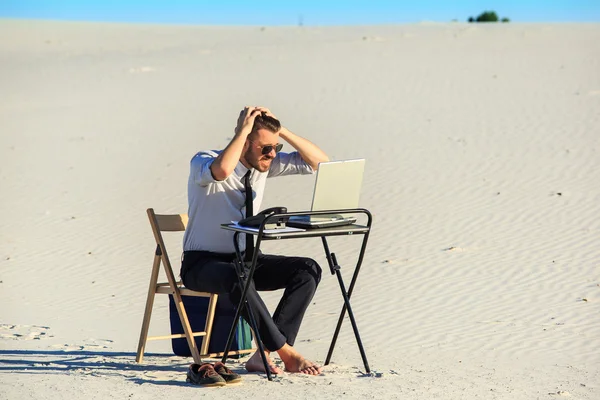 Affärsman med laptop i en öken — Stockfoto