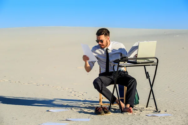 Businessman using  laptop in a desert — Stock Photo, Image