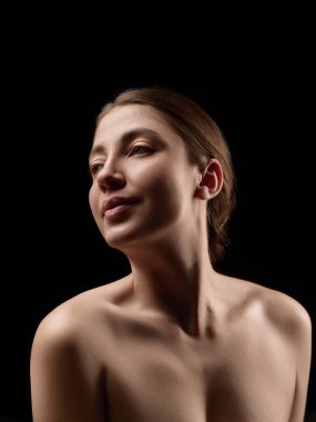 Düşük açık renk kadın portresi siyah arka plana bakıyor. Sosyal konular ve yayın organları için kişisel sınırlar, kendine saygı, bağımsızlık ve görsel hikaye anlatımı kavramı.