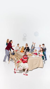 Yemek sırasında neşeli çocuklarla rahat bir aile toplantısı. Ev kıyafetleri koleksiyonu, rahat moda markaları, günlük yemek görselleri, yemek dağıtım reklamları ve ticari yayın kullanımı kavramı.