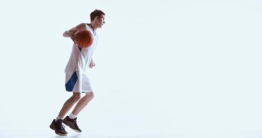 Basketbolcu topa yol gösterirken öne eğiliyor. Teknik geliştirme, fiziksel koşullanma, kontrollü atletik hareket ve uygulama yoğunluğu kavramı.