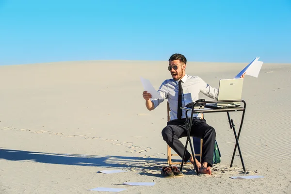 Businessman using  laptop in a desert — Stock Photo, Image