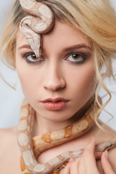 Beautiful girl and a python, which wraps around her body — Stock Photo, Image