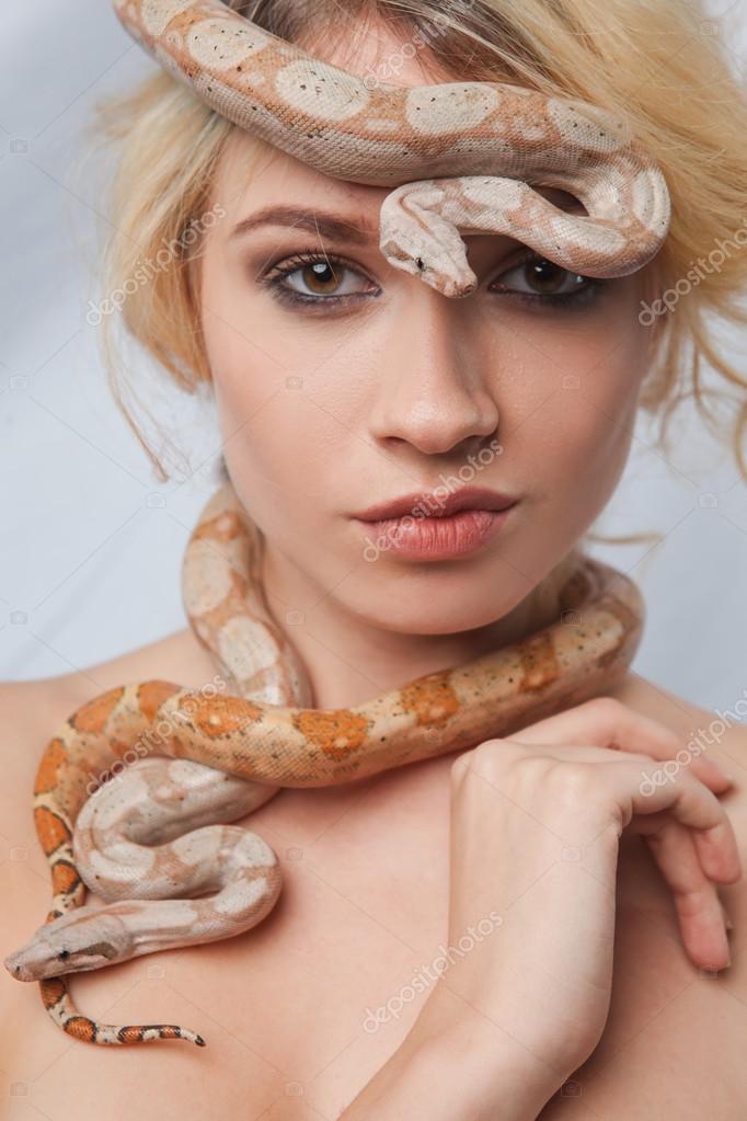 Beautiful girl and the snake Boa constrictors, which wraps around her ...