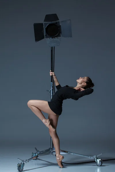 The beautiful ballerina posing on dack blue background — Stock Photo, Image