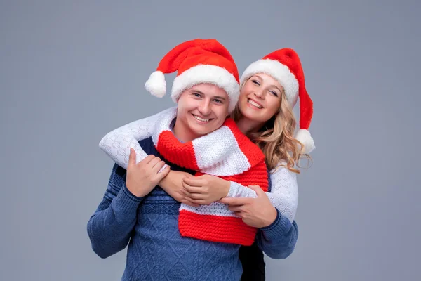 Casal de Natal lindo em chapéus de Papai Noel — Fotografia de Stock