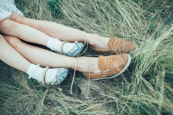 The young mother and daughter on green grass background — Stock Photo, Image