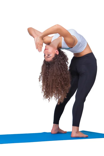 Studio shot of a young fit woman doing yoga exercises. — Stock Photo, Image