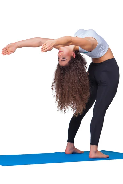 Studio shot of a young fit woman doing yoga exercises. — Stock Photo, Image