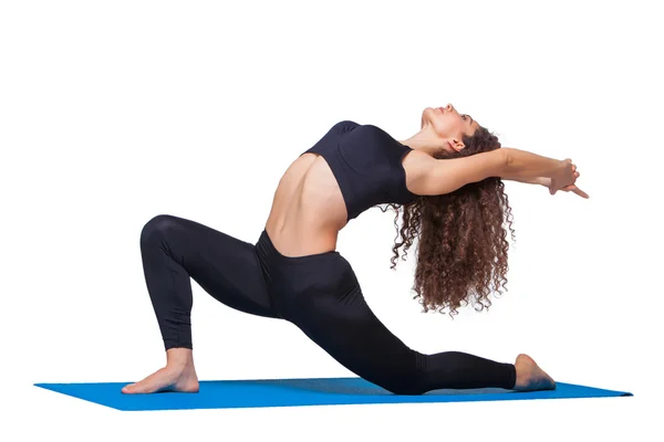 Studio shot of a young fit woman doing yoga exercises. — Stock Photo, Image