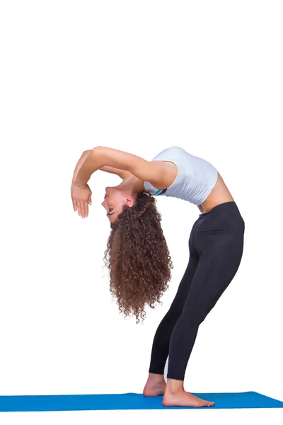Studio shot of a young fit woman doing yoga exercises. — Stock Photo, Image