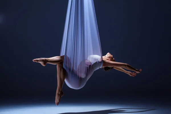 Young beautiful dancer in beige dress posing on gray background — 스톡 사진