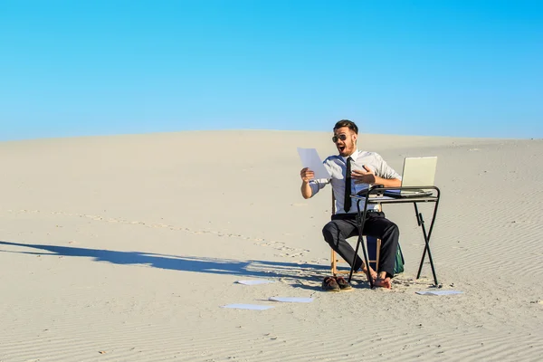 Businessman using  laptop in a desert — Stock Photo, Image