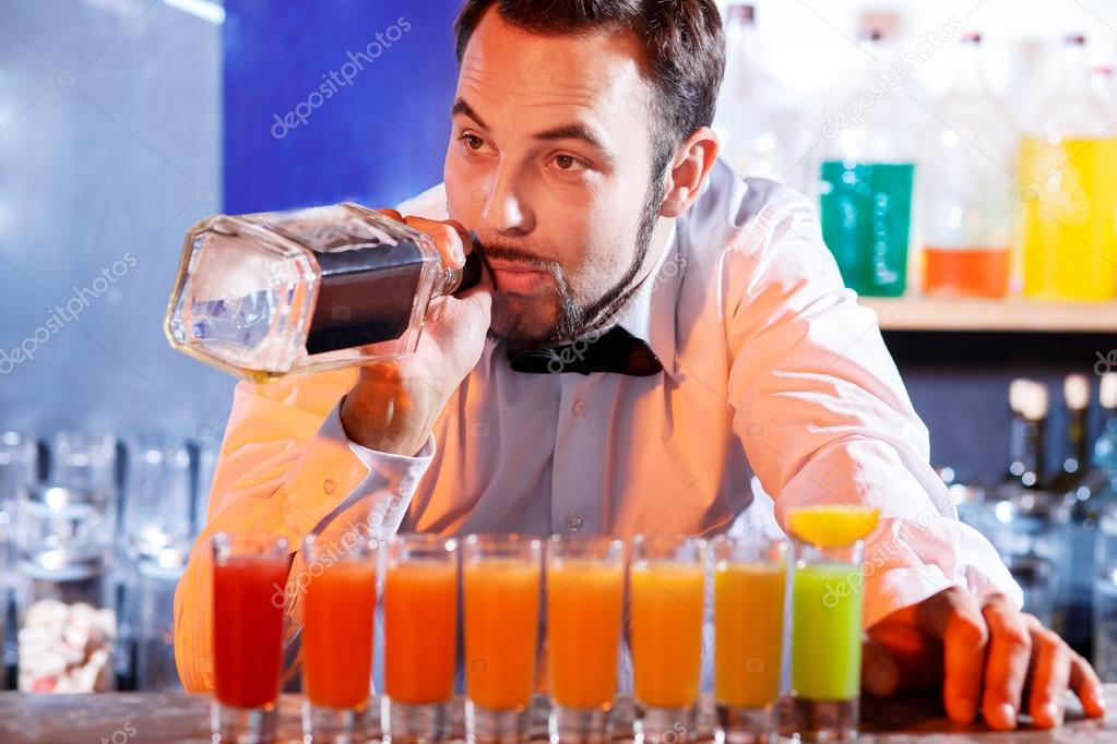 Barman at work, preparing cocktails.