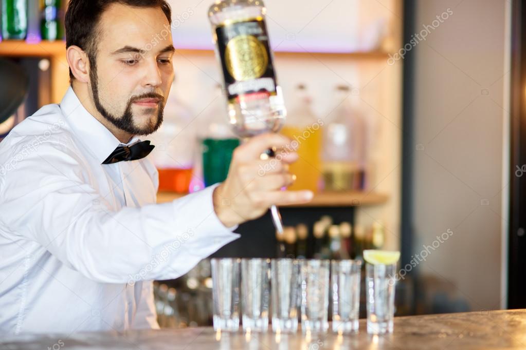 Barman at work, preparing cocktails.