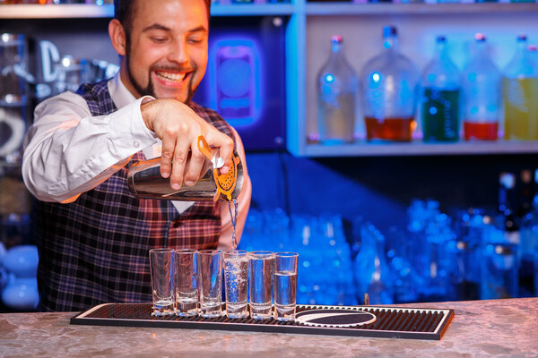 Barman at work, preparing cocktails.