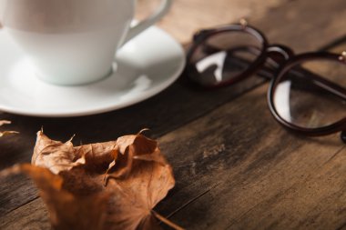 Glasses and cup of coffee on a wooden table
