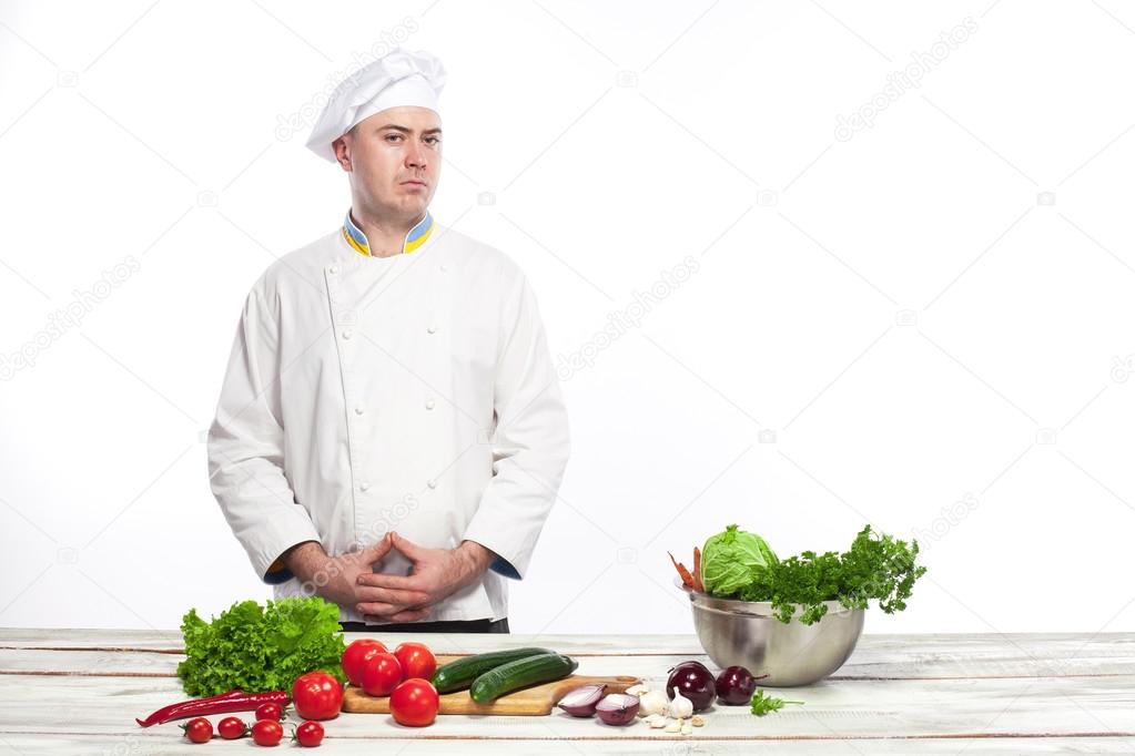 Chef cooking fresh vegetable salad in his kitchen