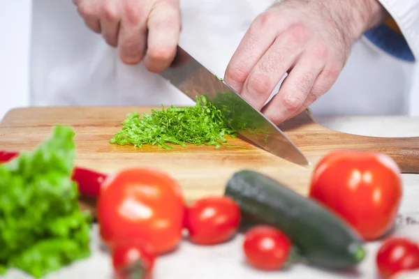 Šéfkuchař řezání zelený salát jeho kuchyně — Stock fotografie
