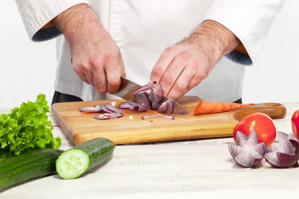 Chef tagliare una cipolla sulla sua cucina — Foto Stock